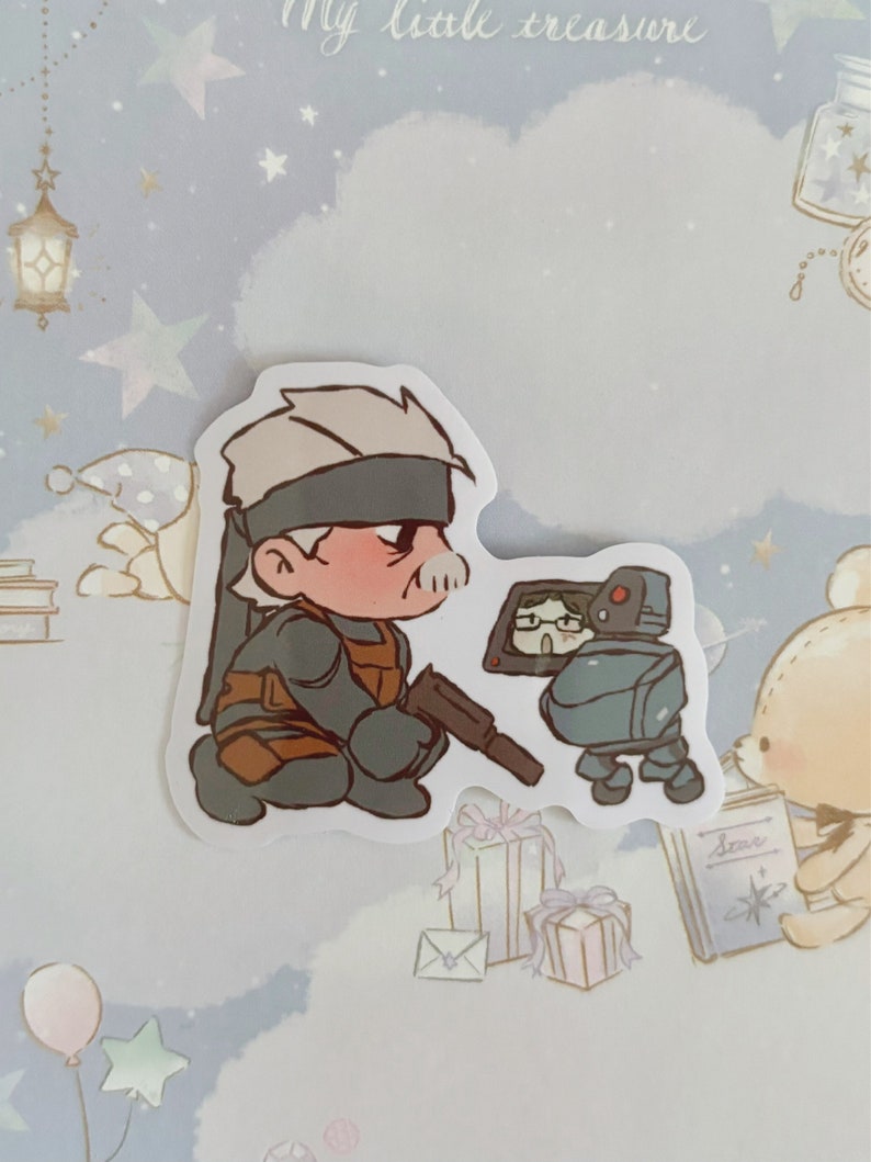 May include: A cartoon sticker featuring a character with a bandana and a gun, looking at a small robot with a screen. The robot is holding a book that says "Stars".