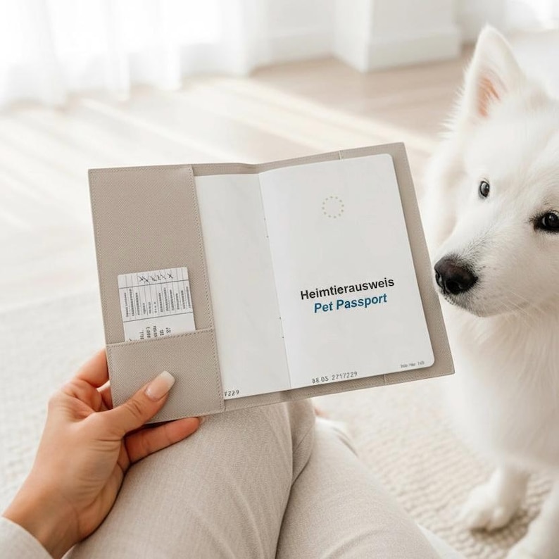 May include: A light beige, textured protective cover holding an open pet passport. The passport features the text Heimtierausweis Pet Passport on the white inner page, along with a small card tucked into the left-hand side pocket slot.