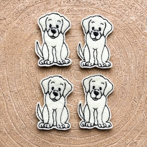 May include: Four white felt dog patches with black embroidered details. Each patch features a sitting dog with a simple, cartoon-like design.