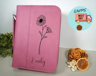 May include: Pink leatherette binder with a floral design and the name "Emily" engraved on the front.