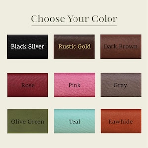 K&ouml;nnte beinhalten: Ein Farbauswahl-Leitfaden mit dem Text "W&auml;hle deine Farbe". Neun Farboptionen werden angezeigt: Schwarz Silber, Rustikales Gold, Dunkelbraun, Rose, Pink, Grau, Olivgr&uuml;n, T&uuml;rkis und Rohleder.