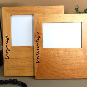 May include: Two wooden picture frames, one larger than the other, with the words "Large Size" and "Medium Size" engraved on the side.
