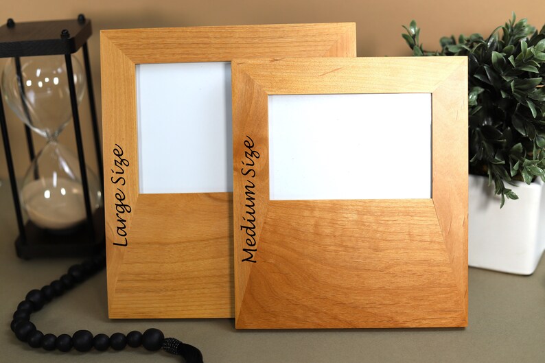 May include: Two wooden picture frames, one larger than the other, with the words "Large Size" and "Medium Size" engraved on the side.