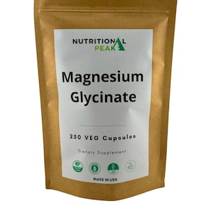 May include: A brown paper bag with a white label that says "NUTRITIONAL PEAK Magnesium Glycinate 250 VEG Capsules Dietary Supplement" with green logos for sugar free, gluten free, non-GMO, and keto friendly. The label also says "MADE IN USA".