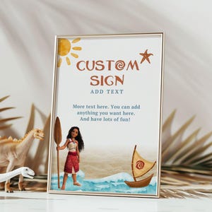 May include: A framed custom sign with a beach theme. The sign features the text "CUSTOM SIGN" and "ADD TEXT" in brown. A cartoon illustration of a woman, a boat, and a sun are also included. The sign is in a gold frame.