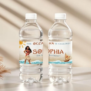 May include: Two clear plastic water bottles with white caps. Each bottle has a custom label featuring a cartoon character, a sun, waves, and the text "THE OCEAN IS CALLING!" and "SOPHIA birthday!"