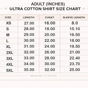 May include: An adult ultra cotton shirt size chart with columns for size, length, chest, and sleeve length in inches. The table lists sizes from XS to 5XL with corresponding numerical measurements for each category, presented in a clear grid format.