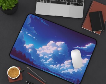 May include: A blue and white mouse pad with a cartoon-style image of clouds and a blue sky. The mouse pad is on a black surface with a laptop, a cup of coffee, and pencils.