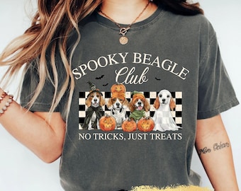 May include: Dark gray t-shirt with the text "Spooky Beagle Club" and a graphic of four beagles dressed in Halloween costumes. The graphic includes pumpkins and the phrase "No Tricks, Just Treats."