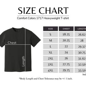 The image is a size chart for a black t-shirt, providing measurements for different chest sizes.