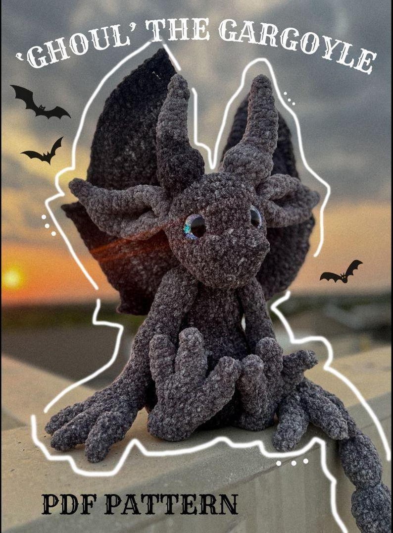 May include: A crocheted gray gargoyle plush toy with large eyes and wings. The toy is sitting on a concrete surface with a sunset in the background. The text 'Ghoul' The Gargoyle' and 'PDF Pattern' are visible in the image.