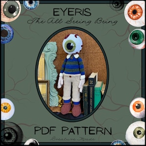 May include: A crocheted doll with an eye-shaped head, wearing a blue and green striped sweater, tan pants, and brown boots. The doll is inside an oval frame with the text "EYEris The All Seeing Being" and "PDF PATTERN".