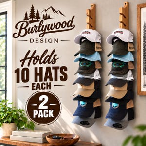 May include: Two vertical wooden wall-mounted hat racks, each holding ten baseball caps in various colors including white, black, blue, and tan. The wall features text reading Burlywood Design, Holds 10 Hats Each, and 2 Pack, with a mountain graphic.