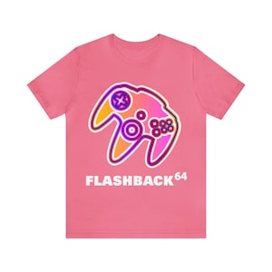 May include: Pink t-shirt with a graphic of a purple, orange, and yellow Nintendo 64 controller. The text "FLASHBACK64" is printed below the controller.