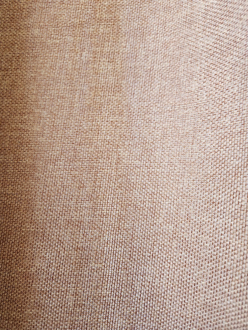 May include: Close-up of a brown woven fabric with a textured surface.