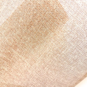 May include: Close-up of a beige burlap fabric with a woven texture. The fabric is slightly wrinkled and has a soft, natural look.