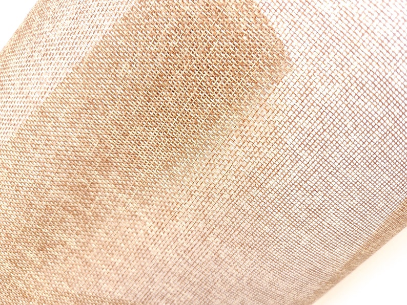 May include: Close-up of a beige burlap fabric with a woven texture. The fabric is slightly wrinkled and has a soft, natural look.
