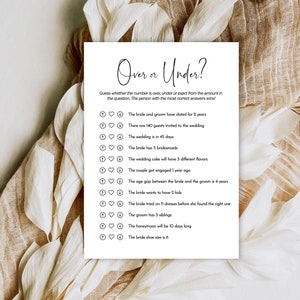 May include: A printable wedding game with the title "Over or Under?"  The game asks guests to guess whether the number in each question is over, under, or exactly the number given.  The person with the most correct answers wins.