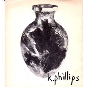 May include: A decorative vase with a unique marbled pattern in shades of black and white. The vase has a rounded body and a narrow neck. The artist's signature, "k.phillips", is written in cursive at the bottom.
