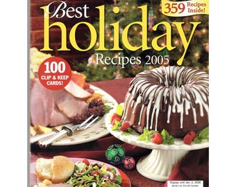 May include: The cover of a cookbook titled "Best Holiday Recipes 2005" features a chocolate bundt cake with white icing, fresh raspberries, and a plate of food. The cover also includes text that reads "Taste of Home's" and "100 Clip & Keep Cards!"