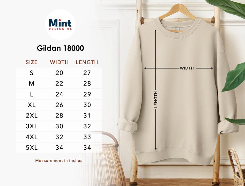 Puede incluir: Una sudadera beige Gildan 18000 colgada en un perchero de madera. La imagen incluye una tabla de tallas con medidas en cent&iacute;metros. El ancho de la sudadera var&iacute;a de 50,8 cm a 86,4 cm, y el largo de 68,6 cm a 86,4 cm. Las tallas van de la S a la 5XL.