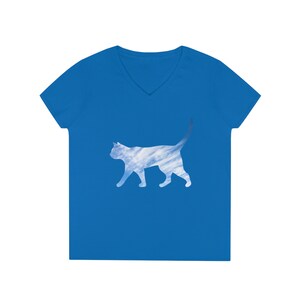 May include: A royal blue v-neck t-shirt featuring a silhouette of a cat. The cat is filled with a cloudy sky pattern.