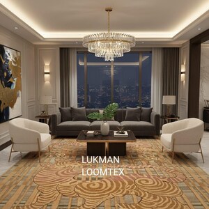May include: An elegant living room with a large chandelier, a dark grey sofa, and two cream armchairs. A patterned rug with a tiger design and the text "LUKMAN LOOMTEX" adds a decorative element to the space. The room has a city view.