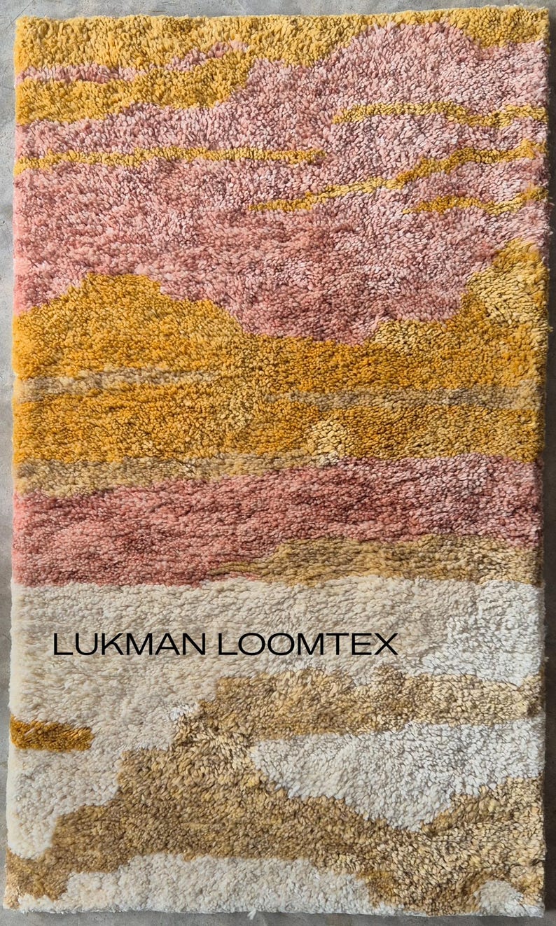 Close-up vertical detail of mid century modern abstract shag rug, plush wool pile in mustard gold, pink, ivory bands.