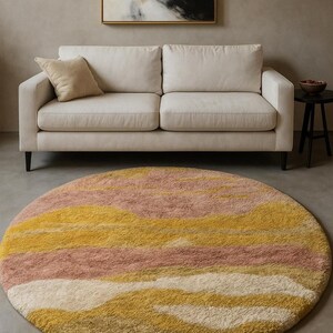 Round abstract shag rug before sofa, concentric warm bands of mustard, terracotta and blush, luxurious wool pile