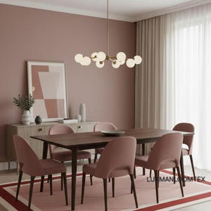 Blush dining room, chandelier over table, pink wool area rug with ivory and deep rose borders.
