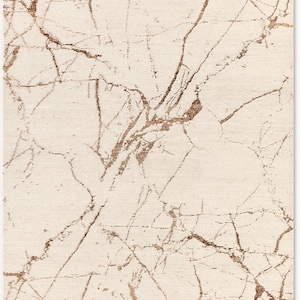 May include: A cream-colored rug with a marbleized pattern in shades of brown and gold.
