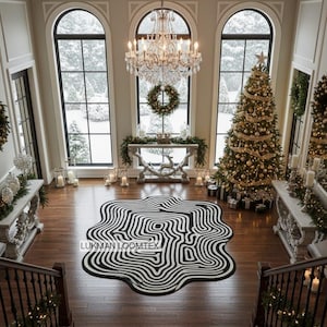 May include: A spacious entrance hall featuring a black and white patterned rug, a decorated Christmas tree, and a chandelier. The rug has an unusual, organic design. The room is decorated for the holidays with garlands, wreaths, and candles.