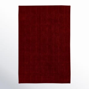May include: A rectangular, deep red rug with a repeating pattern of elongated ovals. The rug has a plush texture and a solid color, making it suitable for various interior design styles.