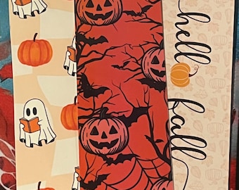 May include: Three rectangular bookmarks with tassels. The left one features ghosts reading books and orange pumpkins on a cream background. The center one has a red background with black bats, spiderwebs, and jack-o'-lanterns. The right one says hello fall.