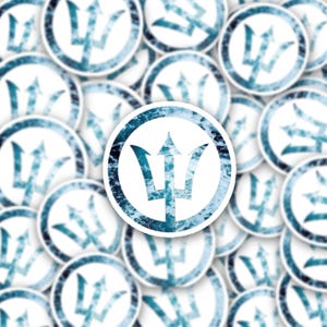 May include: A collection of white, circular stickers featuring a blue trident design. The trident is set against a textured, ocean-like background within a circular border. The stickers are scattered across the image.