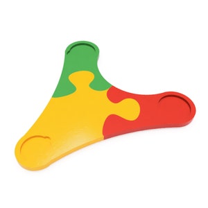 May include: A three-piece puzzle shaped like a triangle. The pieces are green, yellow, and red.