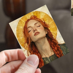 May include: A painting of a woman with long red hair, wearing a green dress, with her eyes closed. She is surrounded by a golden halo.