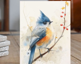May include: Watercolor painting of a blue, gray, and orange bird perched on a branch with red berries. The bird has a blue crest and a long tail. The background is a soft watercolor wash of beige and white.