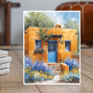 May include: A watercolor painting of a small, yellow adobe house with a blue door. The house is surrounded by purple and yellow flowers.