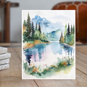 May include: Watercolor painting of a mountain lake scene with a reflection of the trees and mountains in the water. The painting features a blue lake, green trees, and a light blue sky.