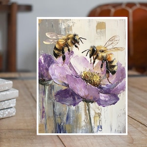 May include: Two bees are perched on a purple flower with a yellow center. The flower has a textured, painterly look. The background is a light gray with hints of gold.