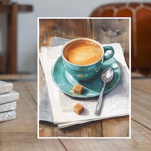 May include: A watercolor painting of a teal blue coffee cup with a saucer and a spoon on a newspaper with two brown sugar cubes. The coffee cup is filled with coffee and the saucer is teal blue.