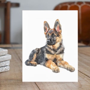 May include: Watercolor painting of a German Shepherd puppy lying down with its head turned to the side. The puppy has black and tan fur and is looking off to the side.