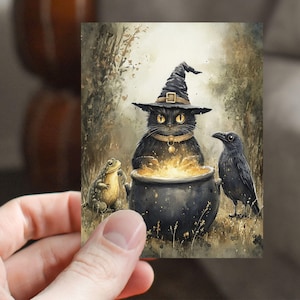 May include: A whimsical watercolor illustration of a black cat wearing a witch's hat, stirring a bubbling cauldron. A frog and a raven are beside the cauldron. The artwork has a Halloween theme.