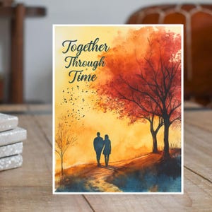 May include: A greeting card with the text "Together Through Time" features a watercolor painting of a couple walking on a path. The background shows a vibrant sunset with trees in shades of red and orange.