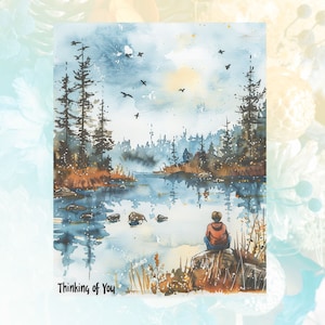 May include: A watercolour painting of a tranquil lake scene with a solitary figure seated on a rock by the water's edge. The lake is bordered by trees and the sky is a soft blue with white clouds. The text "Thinking of You" is written at the bottom of the image.