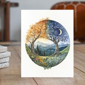 May include: A watercolor painting of a circular design featuring two trees, one with golden leaves and the other with blue leaves, set against a backdrop of mountains and a crescent moon. The trees are intertwined, creating a yin-yang symbol.