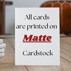 May include: White card with black text that reads "All cards are printed on Matte Cardstock". The word "Matte" is in red.