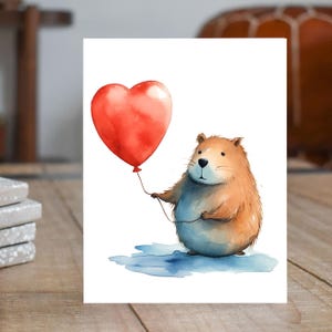 May include: A watercolor illustration of a brown and blue animal holding a red heart-shaped balloon. The animal is standing on a blue puddle.