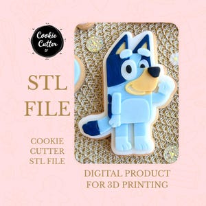 May include: A light blue cookie shaped like a cartoon dog with dark blue ears and details. The cookie is decorated with white icing and a black nose. The image includes the text "STL FILE" and "DIGITAL PRODUCT FOR 3D PRINTING".